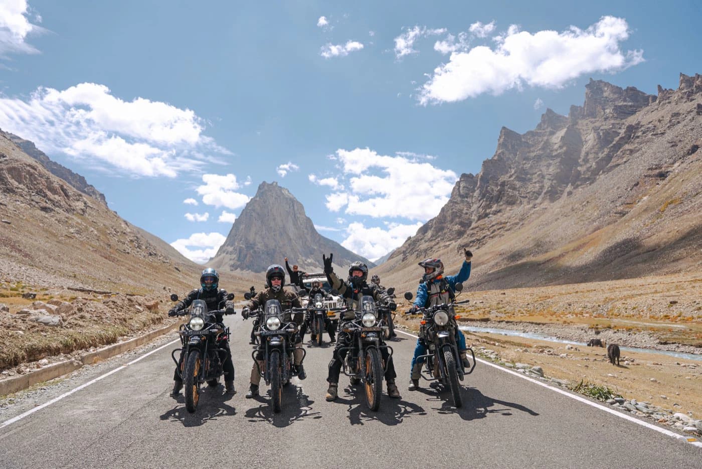 Offhorizon Adventures riders on Royal Enfield Himalayan 450 motorcycles in front of Gonbo Rangjon in Zanskar