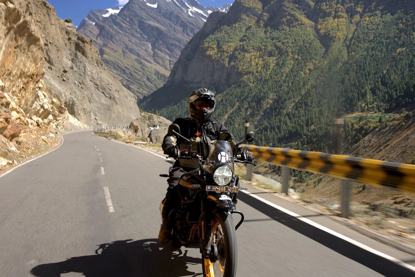 Rider on a Royal Enfield Himalayan 450 on the Manali to Leh highway in a rocky Lahaul gorge on Day 3